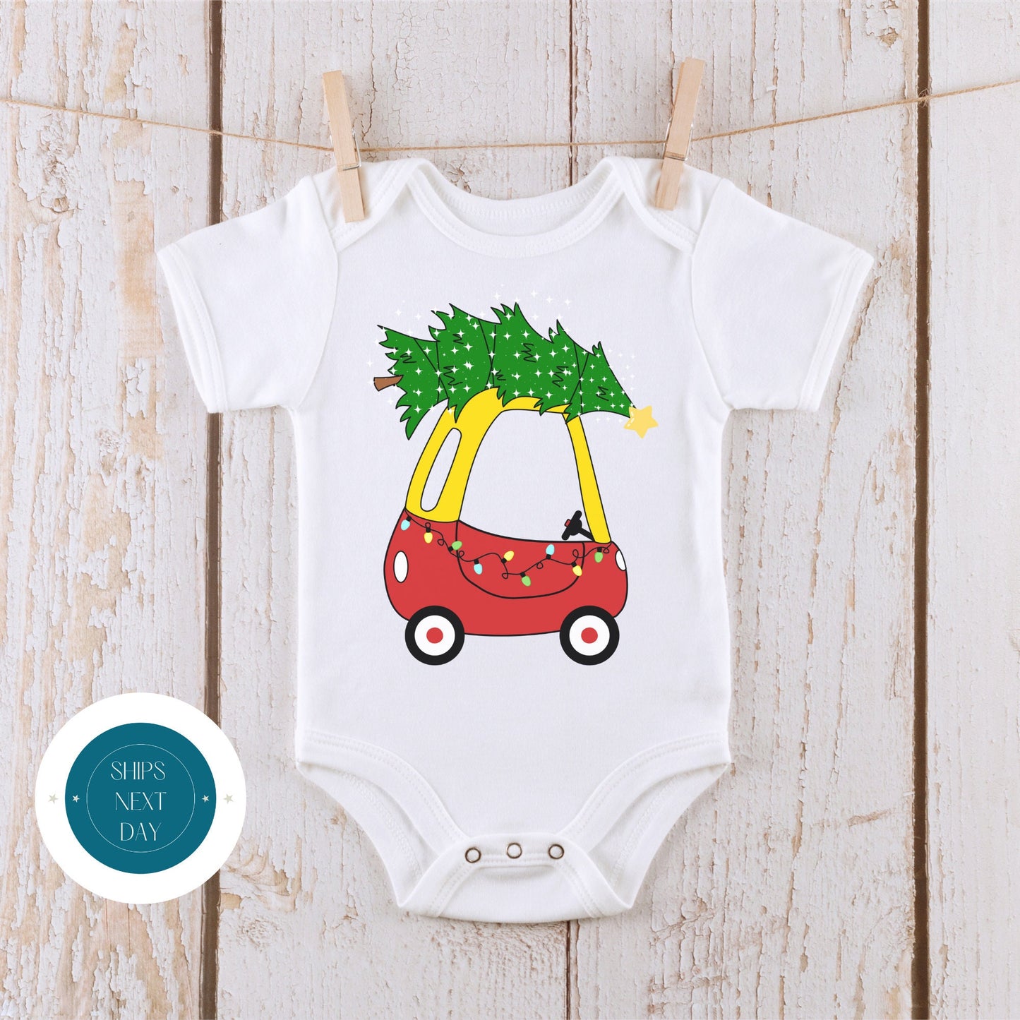 a white bodysuit with a red car and a christmas tree on it